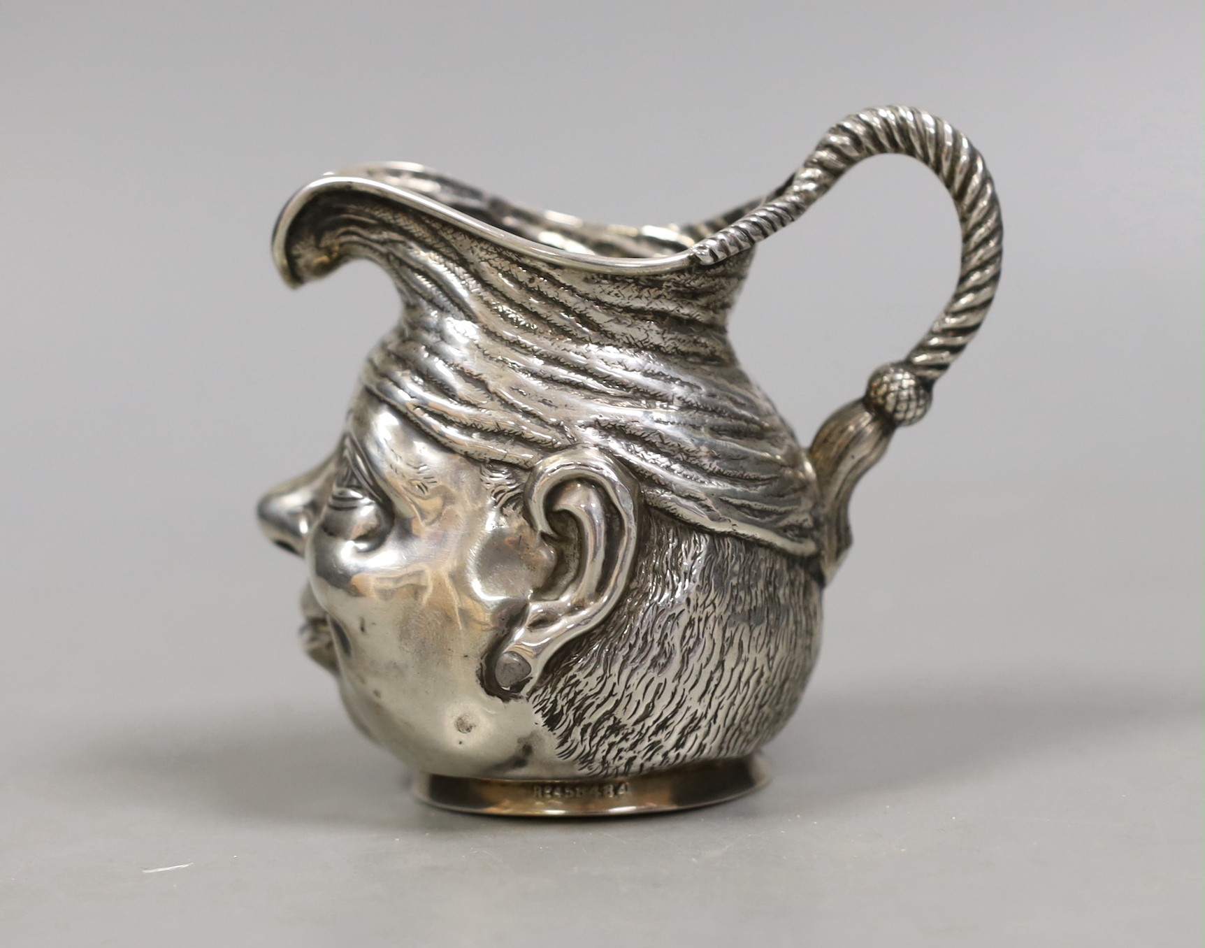 An Edwardian novelty silver 'character' cream jug, Williams Ltd, Birmingham, 1905, 93mm, 100 grams.